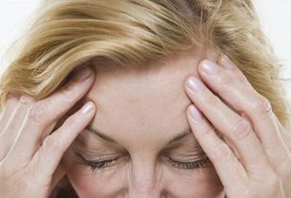 caregiver with headache frustrated